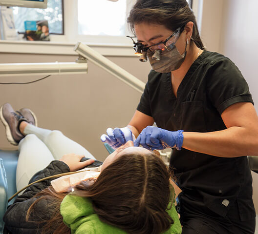Doctor Rakowsky and team member treating dental patient