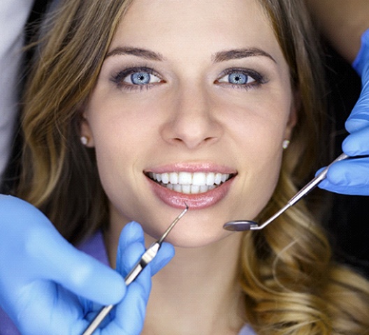 Female dental patient with brilliant white smile leaning back