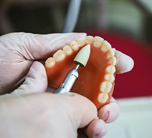 Lab tech filing dentures
