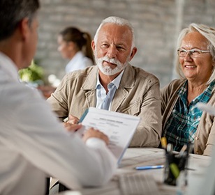 senior couple at a dental implant consultation 