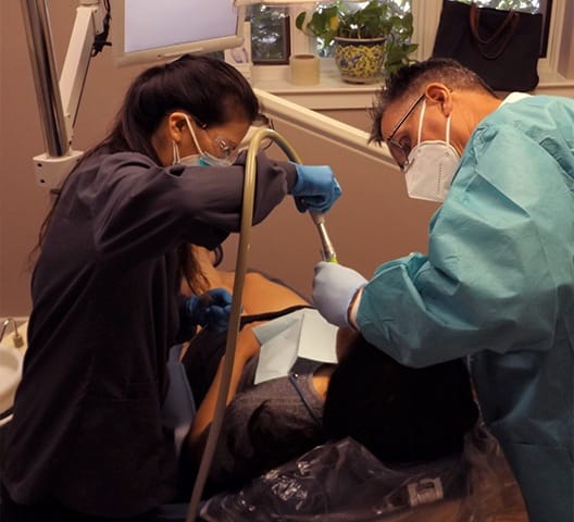 Doctor Rakowsky and team member treating dental patient