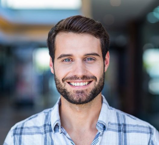 a man smiling after undergoing cosmetic bonding