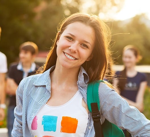 Teen girl smiling after tooth colored filling restoration