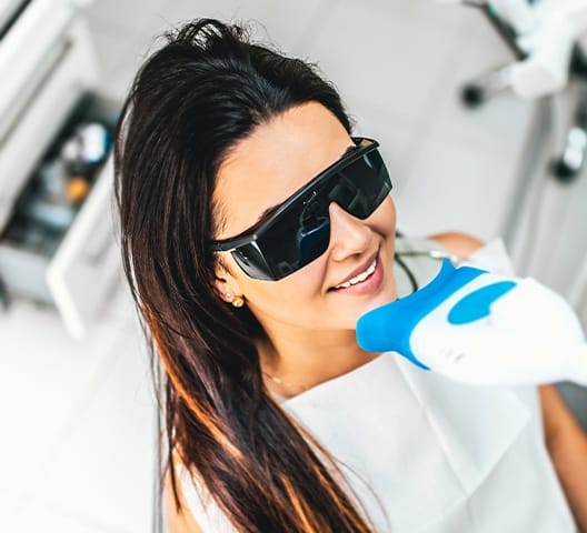 Woman receiving teeth whitening