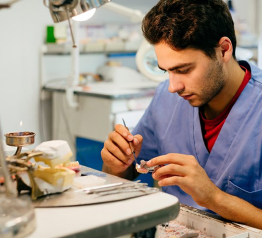 Lab technician customizing a dental crown