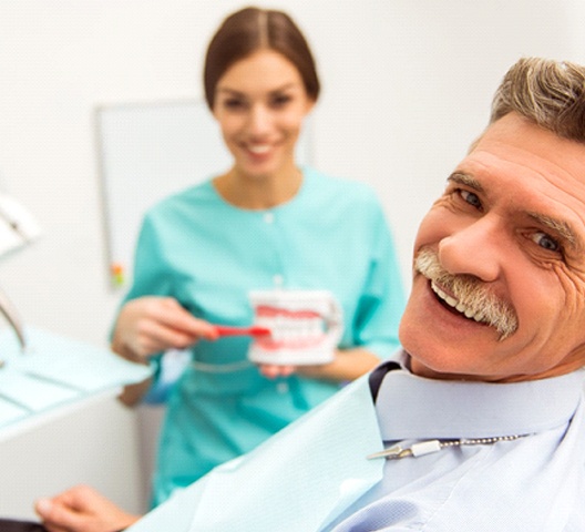 Older man with dentures in Doylestown smiling