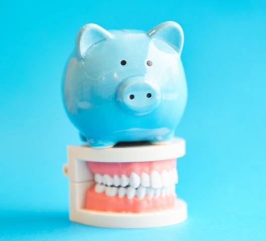 blue piggy bank on a set of dentures in Doylestown 