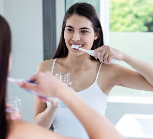 Woman brushing teeth