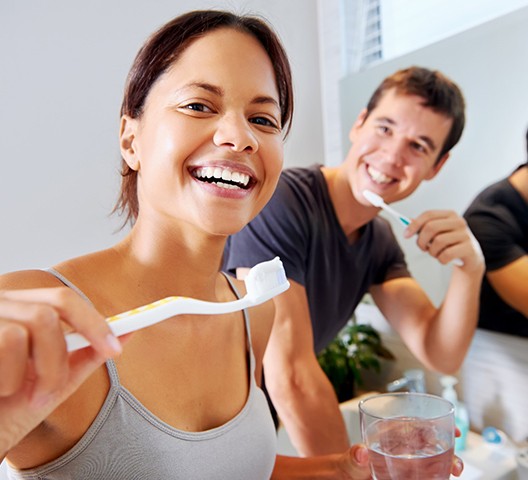 Couple brushing their dental implants in Doylestown