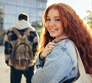 Teen girl smiling while walking outside
