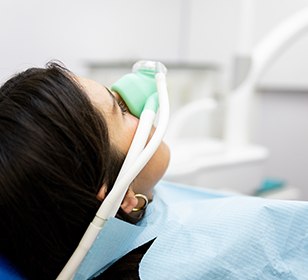 Woman in treatment chair breathing in nitrous oxide