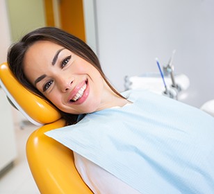 Woman smiling while sitting in treatment chair
