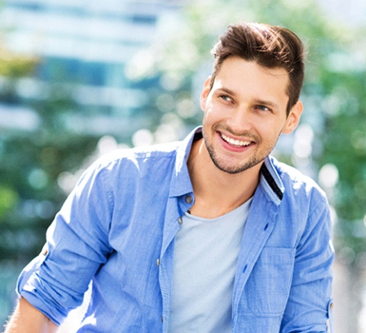 Man in blue jacket with brilliant white smile