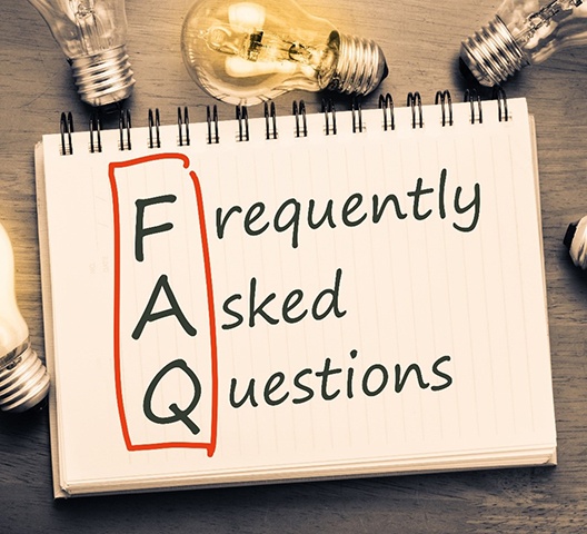 Lightbulbs and notepad that says Frequently Asked Questions