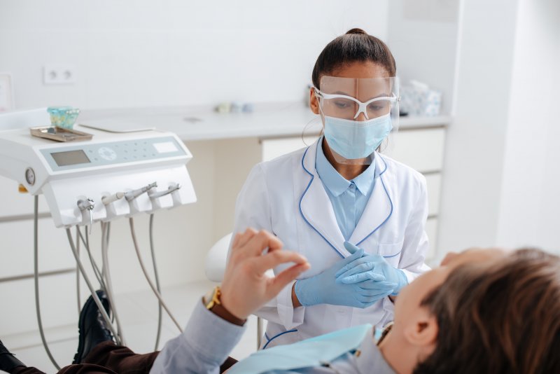 Dentist wearing PPE at appointment with patient