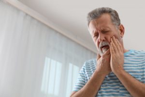 man experiencing tooth pain