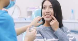 Woman learning about the difference between Invisalign and veneers.