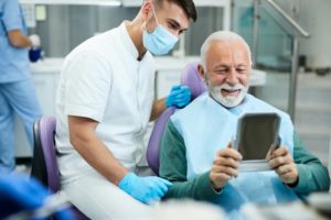 a patient looking in the mirror after a dental cleaning