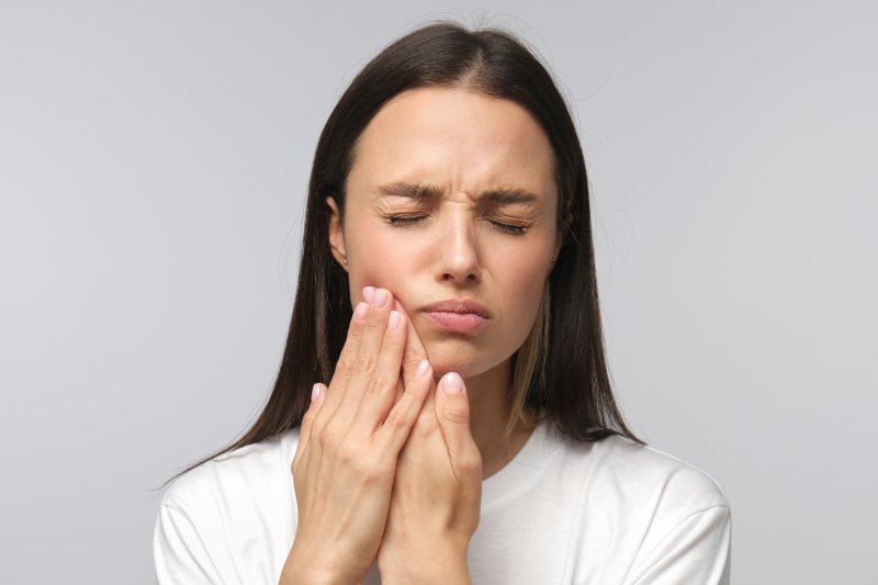 A woman experiencing tooth sensitivity