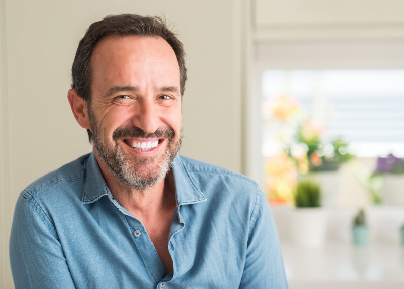 An older man smiling after cosmetic dentistry