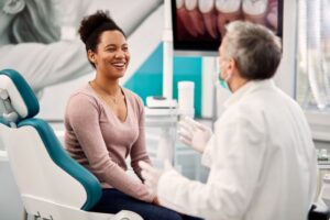 Woman talking to her dentist about dental implant materials